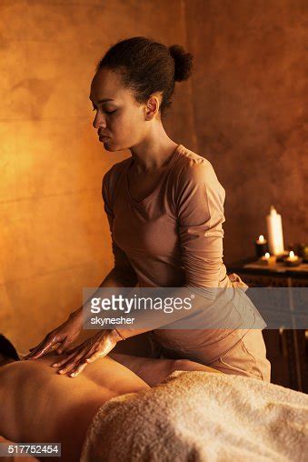 African American Massage Therapist Massaging Mans Back High Res Stock