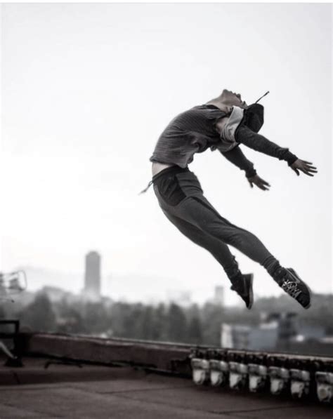 A Man Flying Through The Air While Riding A Skateboard