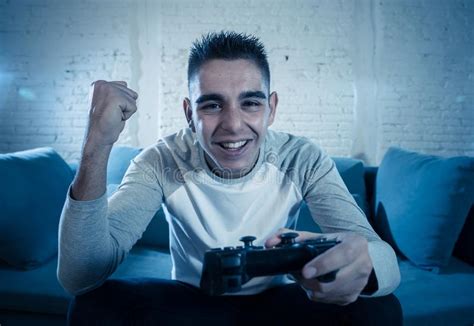 Close Up Portrait Of Young Addicted Man Playing Video Game At Night In