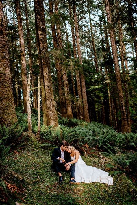Bride And Groom Sitting Amongst The Ferns In A Forest Forest Wedding