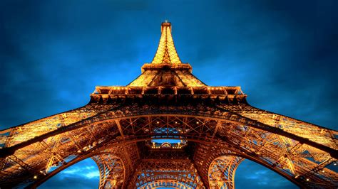 Upward View Of Yellow Lighting Paris Eiffel Tower With Blue Sky