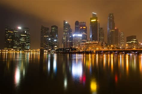 Modern City Skyline At Night With Illuminated Skyscrapers Stock Photo