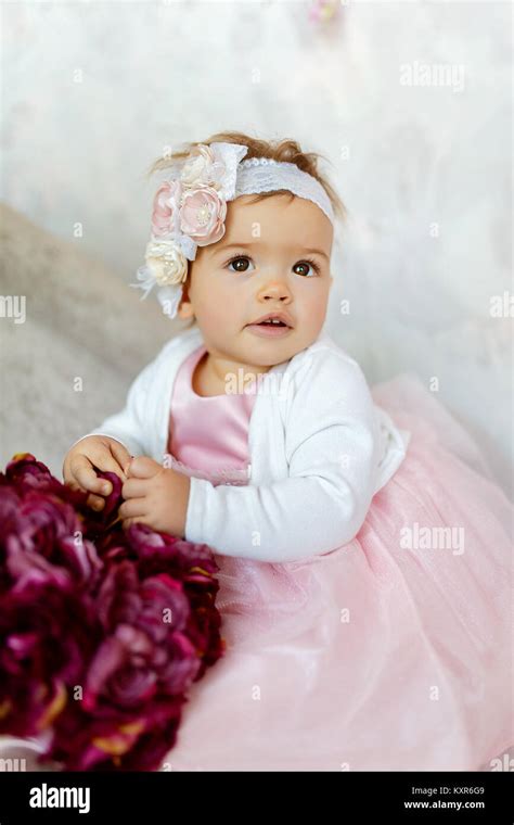 Portrait Of A Beautiful Little Baby In Pink Dress And Close Up Stock