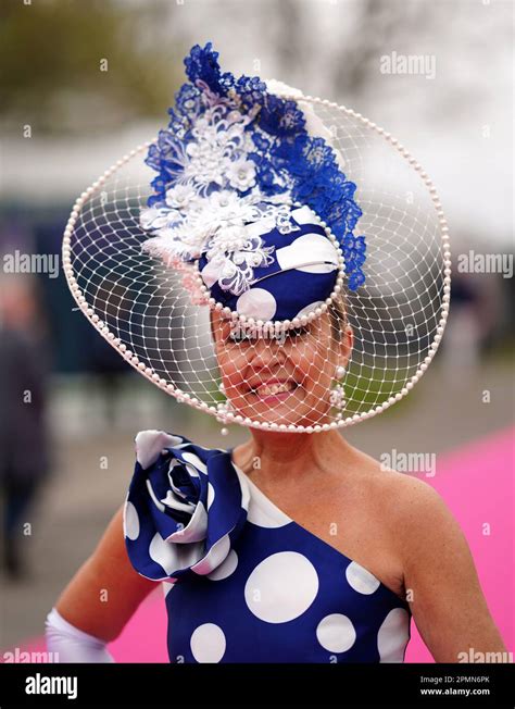 A Racegoer Wearing A Fashionable Hat Arrives For Day Two Of The Randox