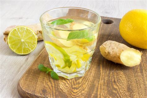 Ginger Ale Soda With Lemon Mint Ginger And Ice Over Rustic Wooden