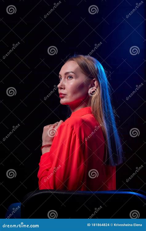 portrait of elegant woman with long hair in red dress and dark background model posing doring