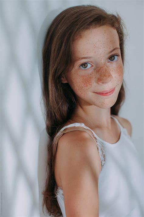 Closeup Portrait Of Adorable Girl With Lots Of Freckles Smiling At Camera Stocksy United