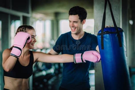 Fit Beautiful Woman Boxer Hitting A Huge Punching Bag Exercise Class In