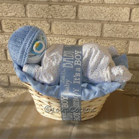 Perfect for a centerpiece at a baby shower. Deluxe Boy Napping Baby Basket(TM) in Blue | Baby shower ...