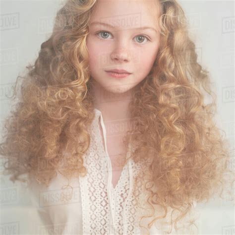 Caucasian teenage girl with curly hair - Stock Photo - Dissolve
