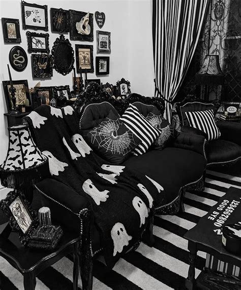 A Black And White Living Room With Halloween Decorations On The Walls