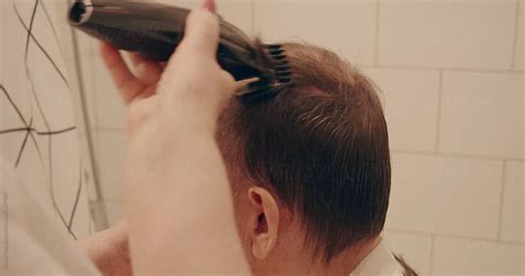Old Woman Cutting Hair Of Her Husband Del Colaborador De Stocksy Alexey Kuzma Stocksy