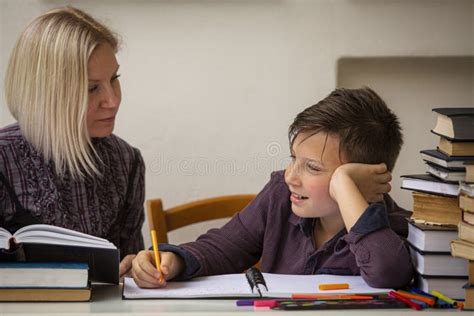 A Junior High School Student Does His Homework With A Female Tutor