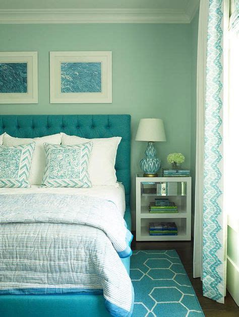 Blue Framed Art Hangs On An Aqua Wall Above A Turquoise Blue Tufted Bed