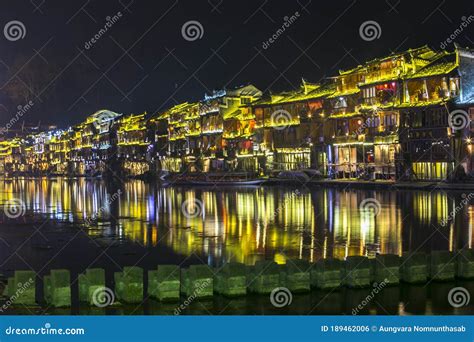 Traditional Chinese Architecture Lit Up And Reflecting Off The Toujiang