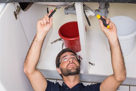 Plumber Fixing Under The Sink Stock Image Image Of Professional