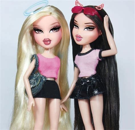 Two Dolls Are Standing Next To Each Other
