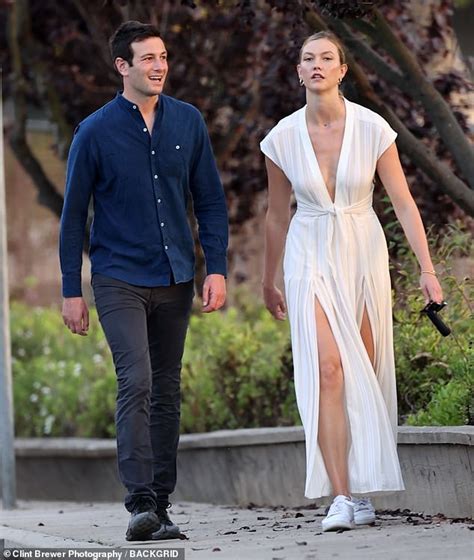 karlie kloss dons a plunging slit dress during a romantic sunset stroll with husband joshua