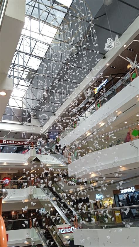 An Indoor Shopping Mall Filled With Lots Of Glass Balconies And