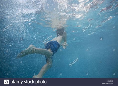Boy Swimming Underwater In Swimming Pool Stock Photo Alamy