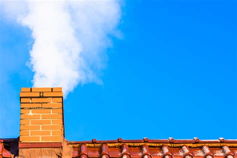 Modern House Roof With Chimney Smoke Air Pollution And Smog In Winter