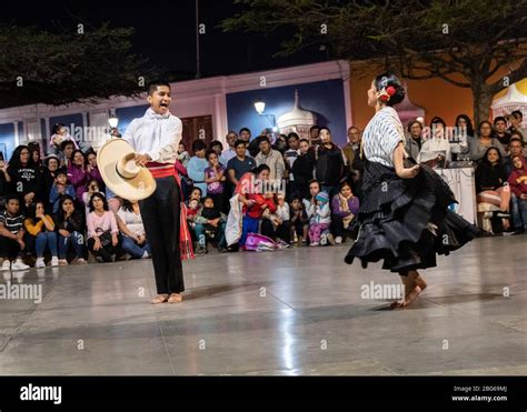 Male And Female Dancers In Traditional Costume Performing La Marinera Norteña Peruvian Dance To