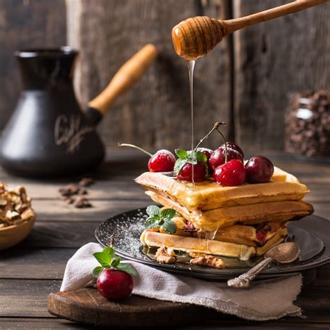 Premium Photo Freshly Made Belgian Waffles With Honey Flows And