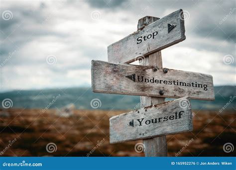 Stop Underestimating Yourself Text On Wooden Rustic Signpost Outdoors