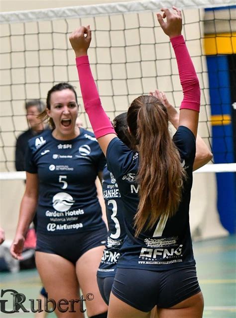 Two Female Volleyball Players Are Celebrating Their Victory Over The