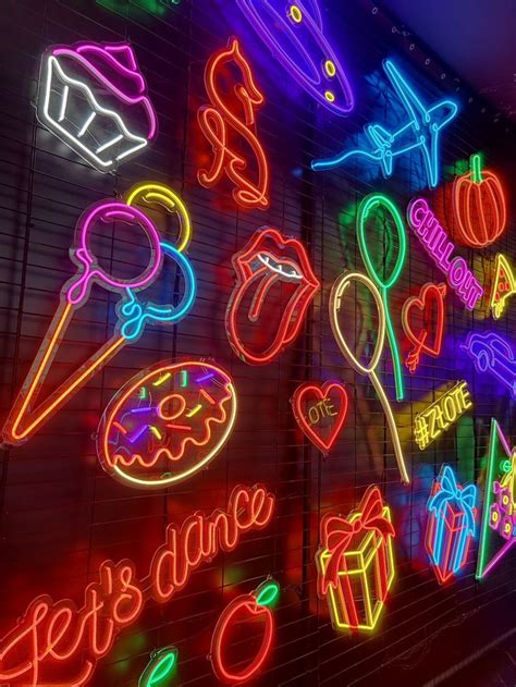 Neon Signs Are Lit Up On The Wall