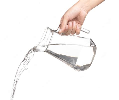 Premium Photo Hand Pouring Water From Glass Jug To Glass Isolated On