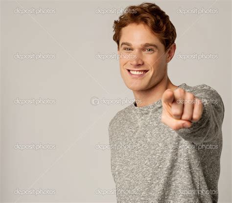 Young Smiling Guy Pointing You Out Stock Photo By ©stockyimages 36383233