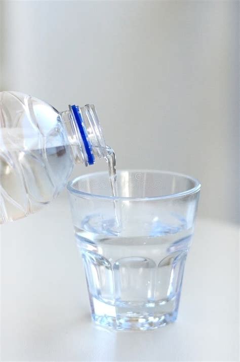 Clean Water Flows From Bottle To Glass Stock Photo Image Of Drink