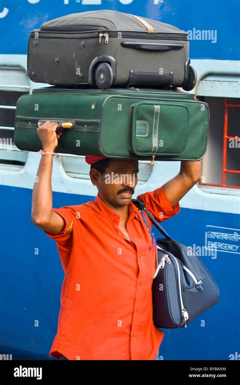 Porter Carrying Luggage At The Railway Station In Hyderabad India Stock