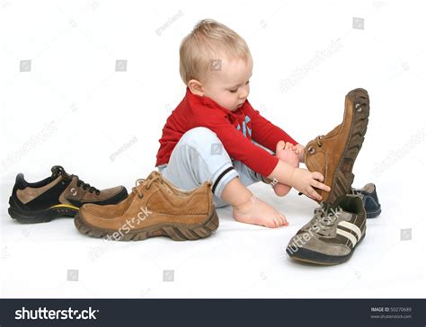Small Child Tries To Put On His Fathers Shoes Baby Boy With Big Shoes