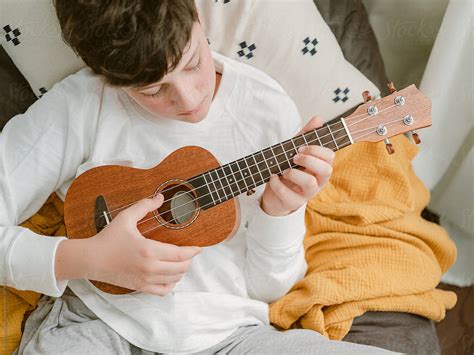 Young Teen Playing A Ukulele By Stocksy Contributor Marta Locklear