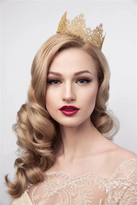 A Woman Wearing A Tiara With Long Hair And Red Lipstick On Her Lips Is