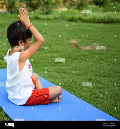 Asian Smart Kid Doing Yoga Pose In The Society Park Outdoor Childrens