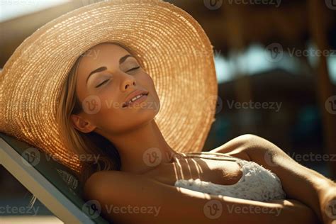 A Close Up Shot Of A Woman In A Bikini Lying Comfortably On A Beach
