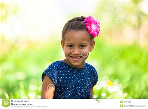 Outdoor Portrait Of A Cute Young Black Girl Smiling