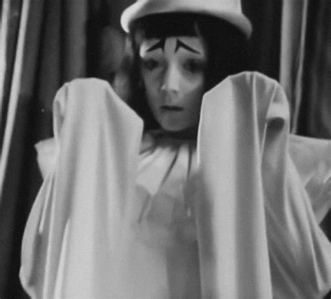 Black And White Photograph Of A Woman In Costume With Her Hands Behind Her Head Looking At The