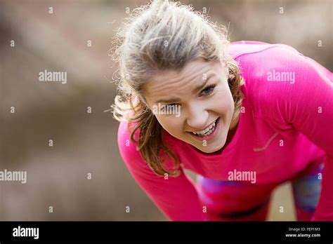 Young Woman Wearing Sportswear Bending Over Exhausted Stock Photo Alamy