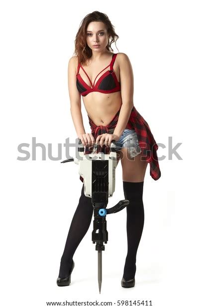 sexy girl in frank clothes with a construction tool jackhammer