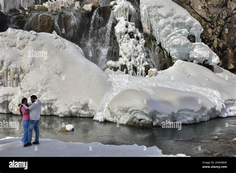 An Indian Couple Take Selfie Near The Frozen Drung Waterfall On A Sunny