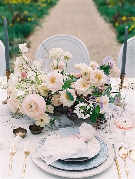 The Table Is Set With White And Pink Flowers