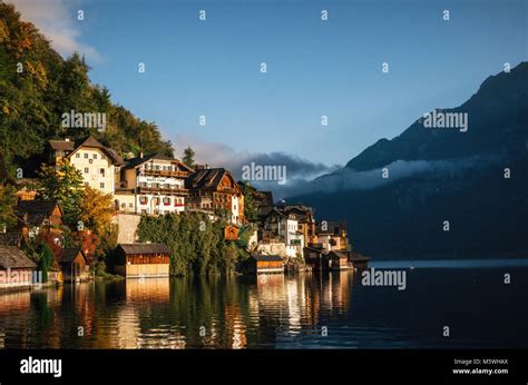 Scenic View Of Famous Hallstatt Lakeside Town Reflecting In