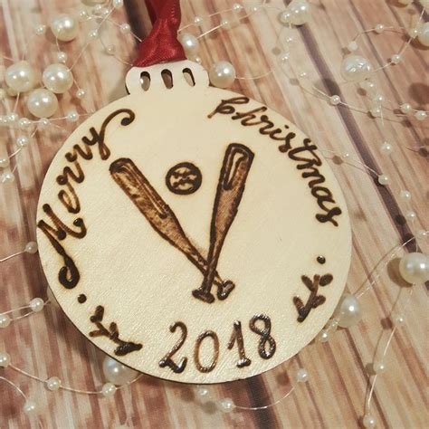 a christmas ornament with two baseball bats on it