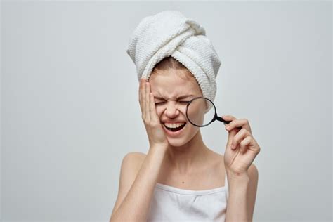 Premium Photo A Woman With A Towel On Her Head Squeezes Out Acne On