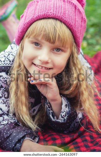 Adorable Little Blond Girl With Long Blond Hair In Autumn Park