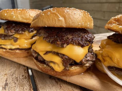 smash burger triple stacked with cheese and a brioche bun foodporn